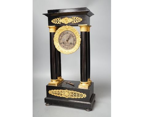 A 19th century ebonised portico mantel clock with brass mounts,46cms high.