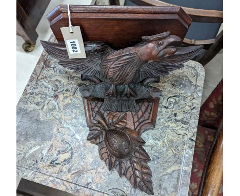 A Black Forest carved eagle wall bracket, width 34cm, height 30cm