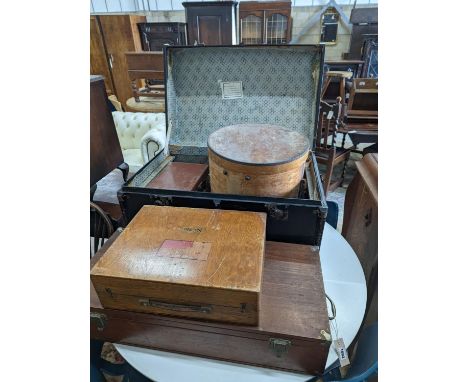 A vintage iron bound wooden travelling trunk, a suitcase, hat box, an artist travel case, and green baize compartments and a 
