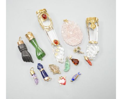 Seven assorted yellow metal or gilt metal mounted clasped hand charm or pendants, largest, 94mm, and seven other smaller char
