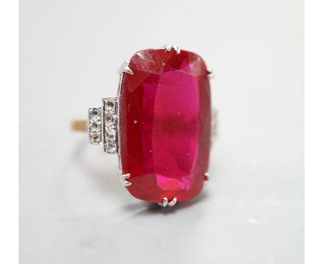 A yellow metal and large synthetic ruby set dress ring, with rose cut diamond set stepped shoulders, size L/M, gross weight 8