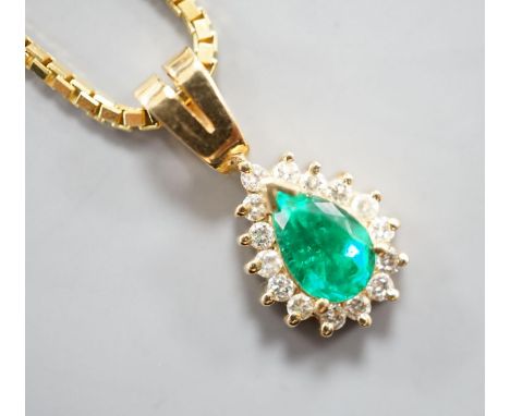 A modern 18k, emerald and diamond cluster set pear shaped pendant, overall 21mm, on an 18k chain, 43cm,gross weight 10.6 gram