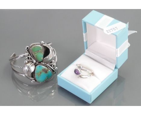 Silver ornate bangle set with turquoise stones: by Kenneth R Begay and a Silver ring set with purple stone. (2)