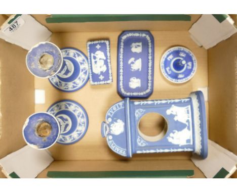A collection of damaged Wedgwood Dip Blue items to include: Tempis Fugit mantle clock, candlesticks, ring stand, tray, lidded