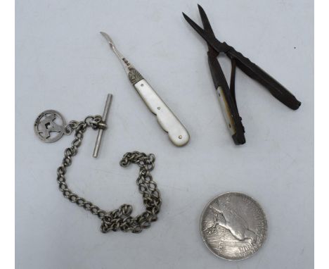 A collection of silver items to include a silver Albert chain and hallmarked silver fob, silver 1922 one dollar coin, silver 