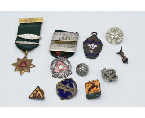 A collection of vintage enamel badges, circa 1930s - 1950s, including silver safe driving medal with war time dates, RAFA lap