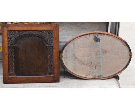 An Arts and Crafts style copper mirror together with a carved 19th century panel / fire screen, mirror 78cm wide (2).  