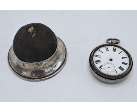 A silver pin cushion and ring holder / trinket box, London 1921 together with a silver cased pocket watch (in need of attenti