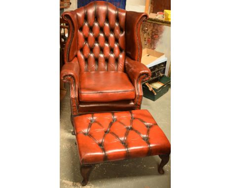 Vintage button back oxblood red leather wingback Chesterfield chair together with footstool, chair 109cm tall.  In good condi