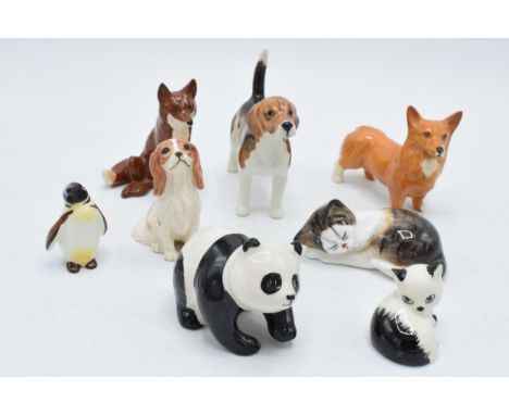 A collection of Beswick animals to include penguin chick, panda, corgi, sitting fox, Royal Doulton cat (seconds) and Szeiler 