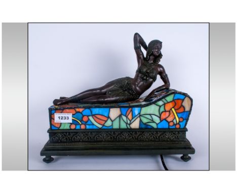 Modern Lamp In The Art Deco Style Of A Reclining Girl On A Leaded Glass Couch, acting as a lamp. 14'' in width, 12'' in heigh