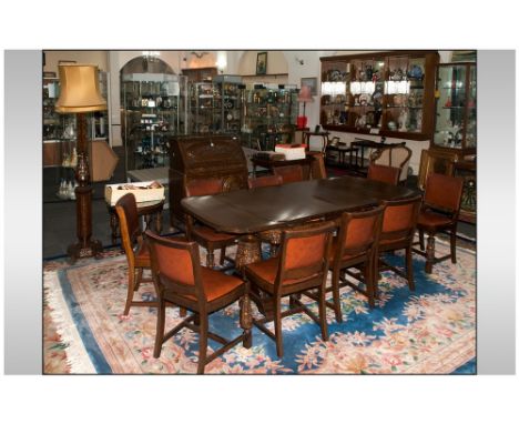 1930's Profusely Carved 17 Piece Oak Dining Room Suite, consisting of an extending drawer leaf table on a pedestal base on cr