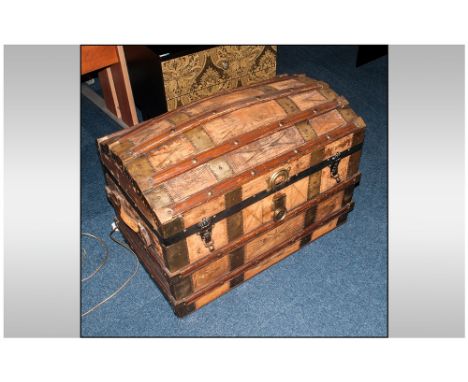 Antique Leather Clad Domed Top Travelling Trunk, with wood strapping to the top and sides with carrying handles, with interio