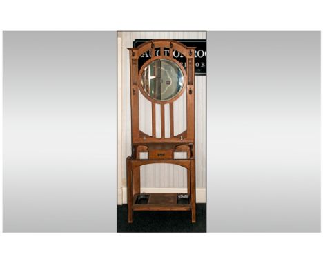 Art Nouveau Oak Hallstand With A Round Central Mirror supported on three slats, drawer to the centre flanked by stick stand w