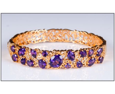Amethyst Art Nouveau Style Filigree Bangle, a variety of cuts of deep purple amethyst, oval, pear and round, centred by a 2.2
