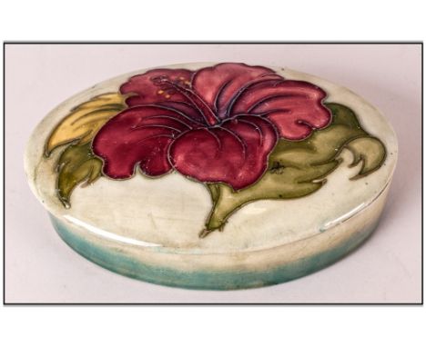 Moorcroft Oval Shaped Lidded Trinket Box / Jar ' Hibiscus ' Design. Pale on Green Ground. 5 Inches Diameter. 