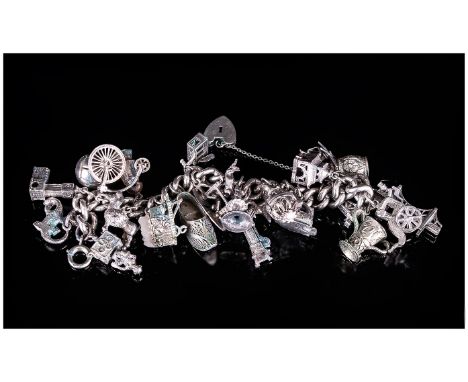 A Vintage and Heavy Silver Curb Bracelet, Loaded with 28 Silver Charms of Various Subjects and Sizes. Good Quality Charms. We