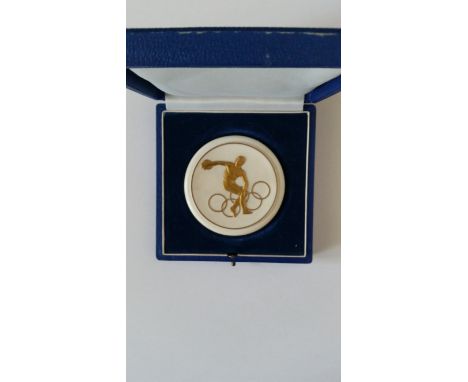 OLYMPICS, a circular ceramic participation medal for the East German team, undated, in fitted case, EX