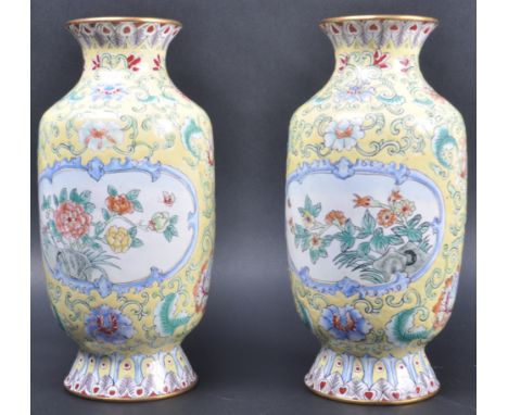 A pair of 20th Century Chinese Canton enamel vases. Both with famille jaune ground with white porcelain panels decorated with