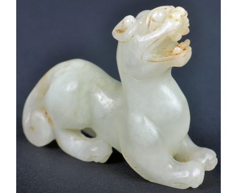 A 19th Century Chinese Qing Dynasty Oriental hand carved jade figurine in the form of a Foo Dog / Dog of Fo. The figure model