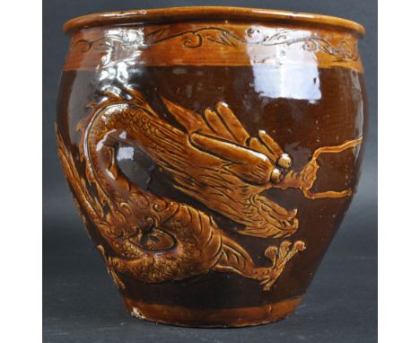 A 19th Century Chinese brown glazed terracotta 100 year egg pot planter jardiniere. Brown glaze with dragon &amp; phoenix cha