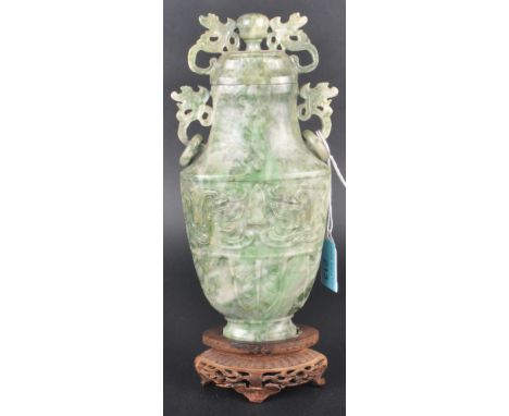 A 19th Century Chinese hand carved jade stone lidded urn of archaistic vase shape. Fret pierced dragon adornments with ring h