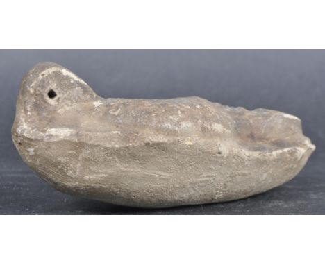 A 1st-3rd Century BC Egyptian clay terracotta pottery oil lamp. Carved decoration depicting face mask with open hole and burn