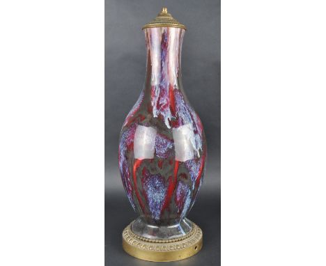 A 19th Century Chinese Flambe Sang De Boeuf porcelain vase table lamp. Ormolu mounted with tapered neck and baluster form bod