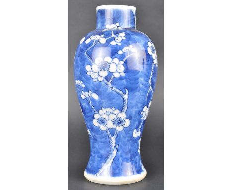 A 19th Century Chinese Kangxi mark blue and white vase decorated in the prunus pattern with hand painted decoration depicting