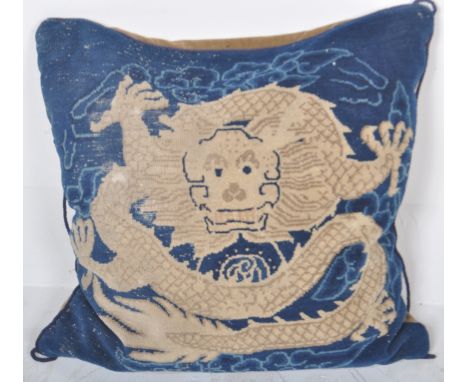 An early 20th Century Chinese floor cushion of large size having an embroidered woollen imperial dragon set to blue ground. T