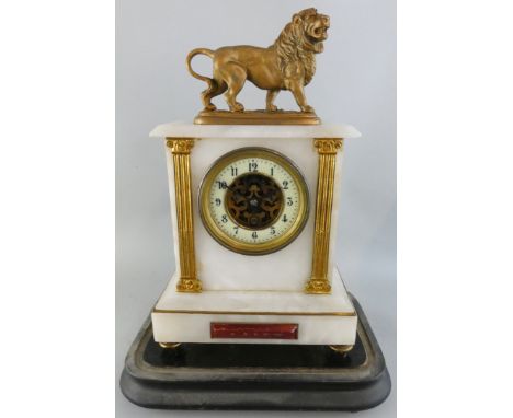 A 19th century French white marble and gilt metal exposed escapement mantle clock, the architectural case with lion surmount,