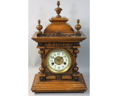 H. A. C. - a German fourteen day walnut mantle clock, the movement striking on a gong, numbered 3061, architectural case, pen