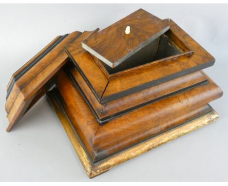 A Victorian burr walnut and ebony strung sarcophagus tea caddy, the lift off cover revealing a lidded compartment, gilt base,