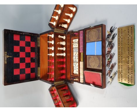 A Victorian rosewood and ebony strung games compendium, containing folding chess &amp; backgammon board, red stained &amp; na