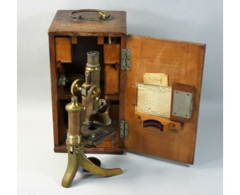 An early 20th century cased E Leitz Wetzlar microscope, with gilt and black lacquer finish, the case with fitted compartments