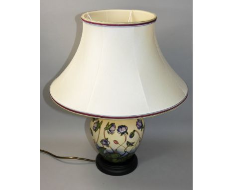 A Moorcroft 'Hepatica' pattern tube line decorated lamp with shade, of baluster shape with original Moorcroft shade, designed