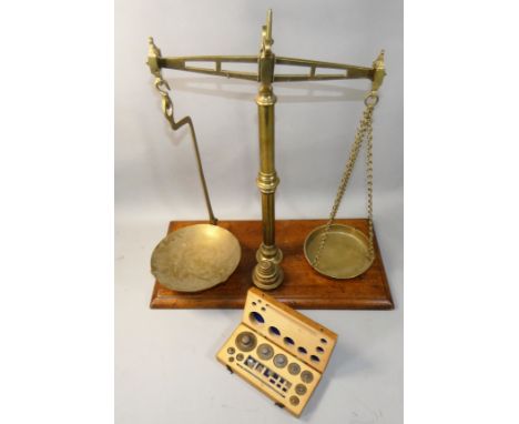 A set of Day &amp; Millward brass and weighing scales on an oak base, overall height 53cm, together with a boxed set of Griff