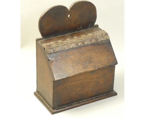 An early 19th century oak country made salt box, with heart shaped bracket and leather hinge, height 24cm.