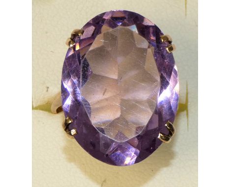 A 9ct rose gold mounted amethyst ring, four claw set with on oval mixed cut stone, 25 x 20 mm, size R.