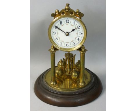 A brass anniversary clock, the white dial with Arabic numerals, beneath a glass dome, height 29cm.
