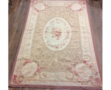A LARGE 20TH CENTURY AUBUSSON RUG Floral spray design to central oval field on a light tan ground, with classical style scrol