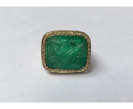 HIRSH, A HALLMARKED 18CT GOLD, CARVED EMERALD AND DIAMOND COCKTAIL RING Large rectangular cabochon emerald carved to both upp