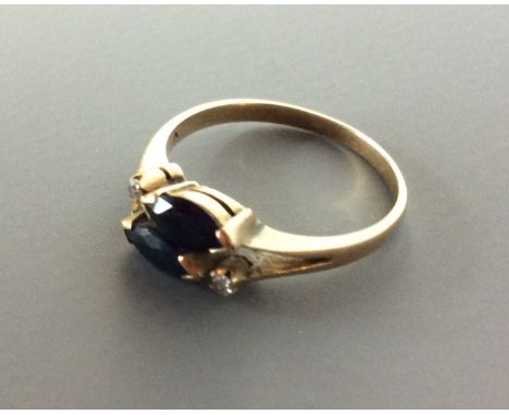 A 14CT GOLD, SAPPHIRE & DIAMOND RING having two oval cut sapphires set with two diamonds. Size K/L  