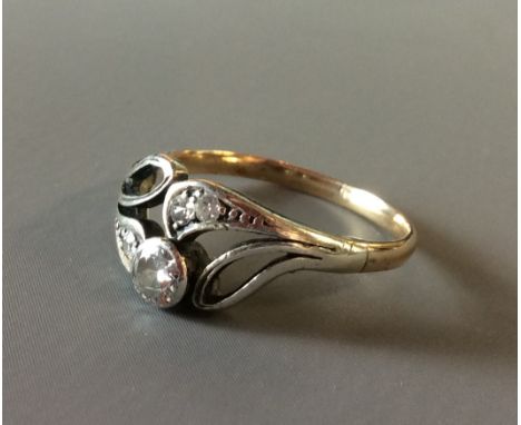 A VINTAGE 9CT GOLD AND DIAMOND RING Having a round cut diamond collet set in a pierced and scrolled diamond set mount (size K