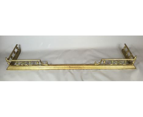 A 19TH CENTURY BRASS FIRE FENDER With swag motifs and shaped finials to the gallery. (w 150cm x d 38cm) 