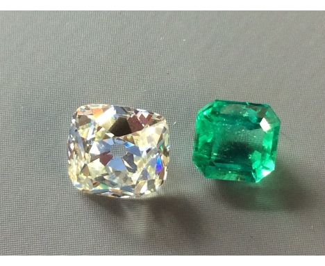 A LOOSE SOLITAIRE CUSHION CUT DIAMOND  Together with a loose Colombian emerald. (diamond weight 1.1ct) (emerald 0.3ct)  