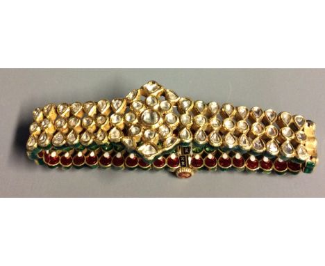 A RARE AND UNUSUAL INDIAN 21CT GOLD, DIAMOND AND ENAMEL REVERSIBLE BRACELET Having over one hundred old cut diamonds in a flo