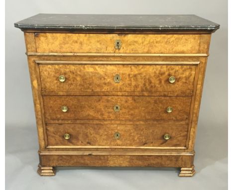 A 19TH CENTURY FRENCH BURR WALNUT COMMODE With black marble top over singe frieze and three long drawers, raised on shaped fe