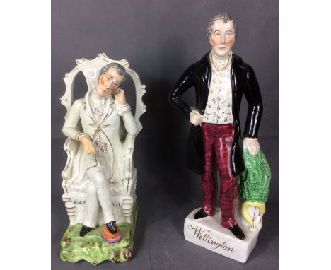 TWO 19TH CENTURY STAFFORDSHIRE POTTERY FIGURES OF THE DUKE OF WELLINGTON standing pose wearing a black morning coat, with one