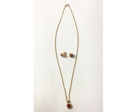 A 9CT GOLD, RUBY AND DIAMOND CLUSTER PENDANT AND EARRING  Set with an oval cut ruby claw set to a scalloped diamond set surro